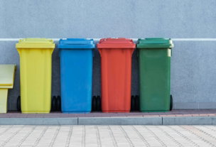 four-assorted-color-trash-bins-beside-gray-wall.jpg four assorted-color trash bins beside gray wall